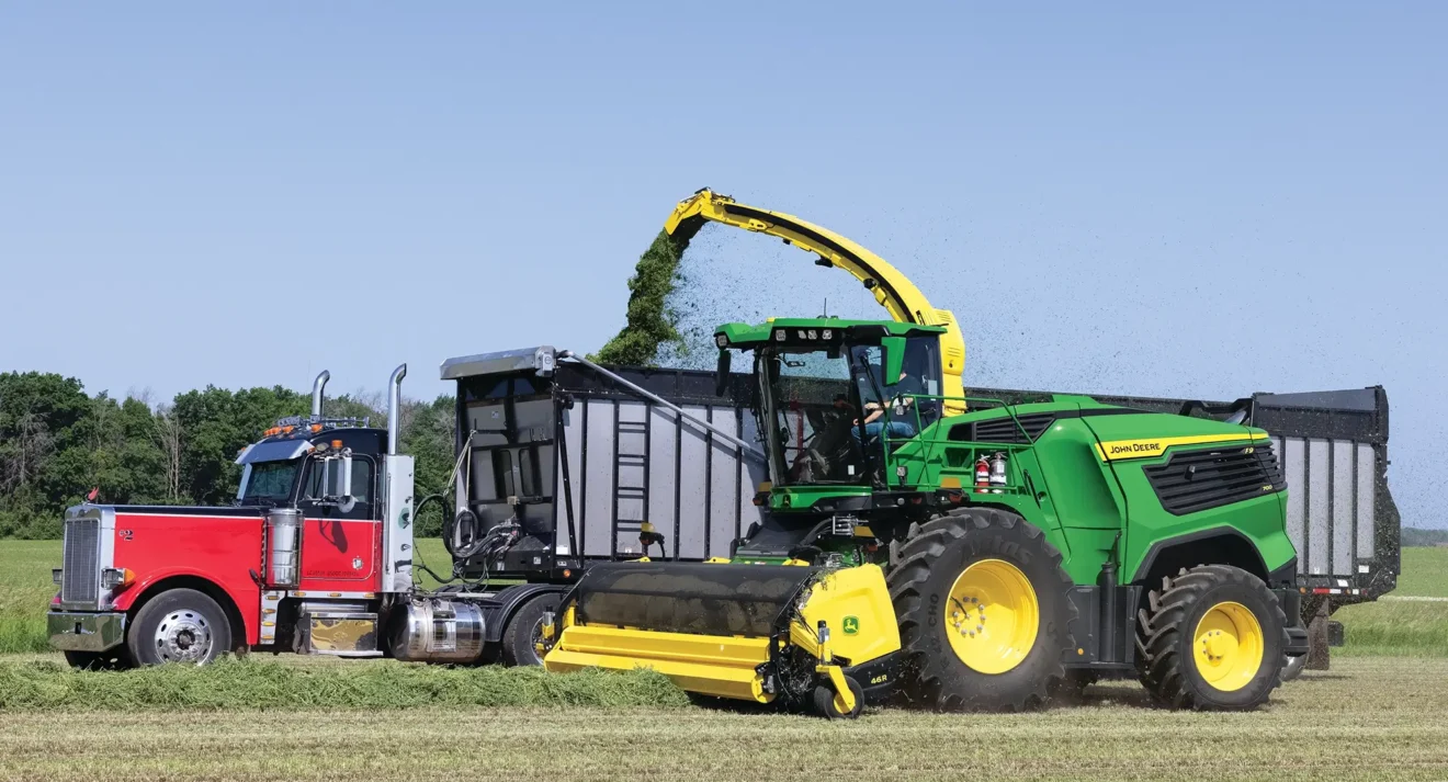 Harvesting in field beside a semi truck