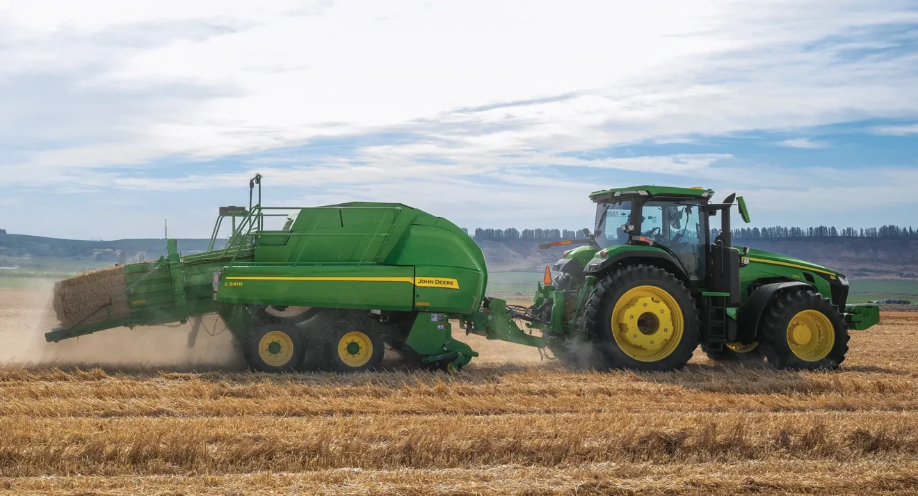 Haying used equipment working in field