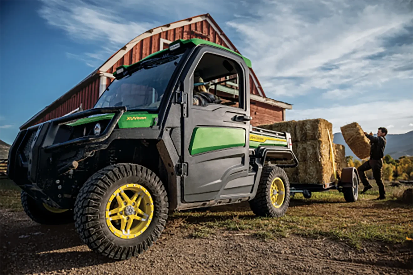 Farmer loading hay using his ATV